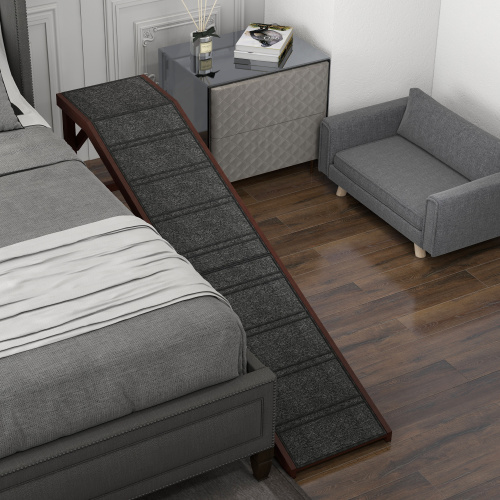A dog ramp with a top platform set against the side of a bed