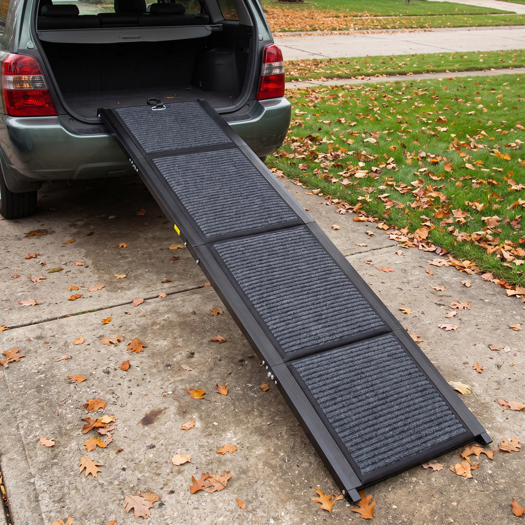 Folding dog car ramp opened from the driveway to the cargo floor of an SUV