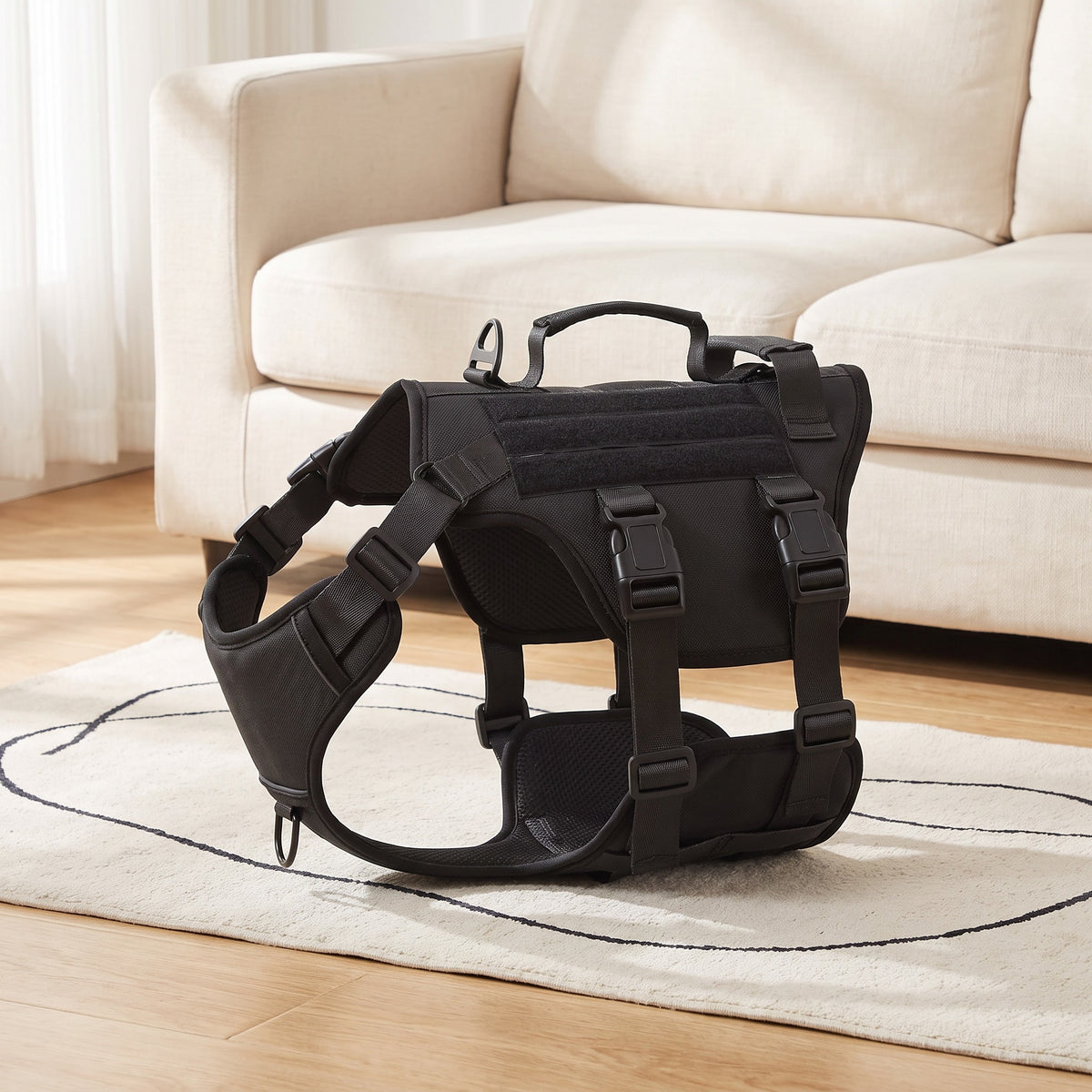 Black dog harness with two handles on a rug in a living room