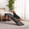 Earl, our brand mascot, a senior dachshund in a green sweater, walking up the dog ramp to a bed in a bright bedroom